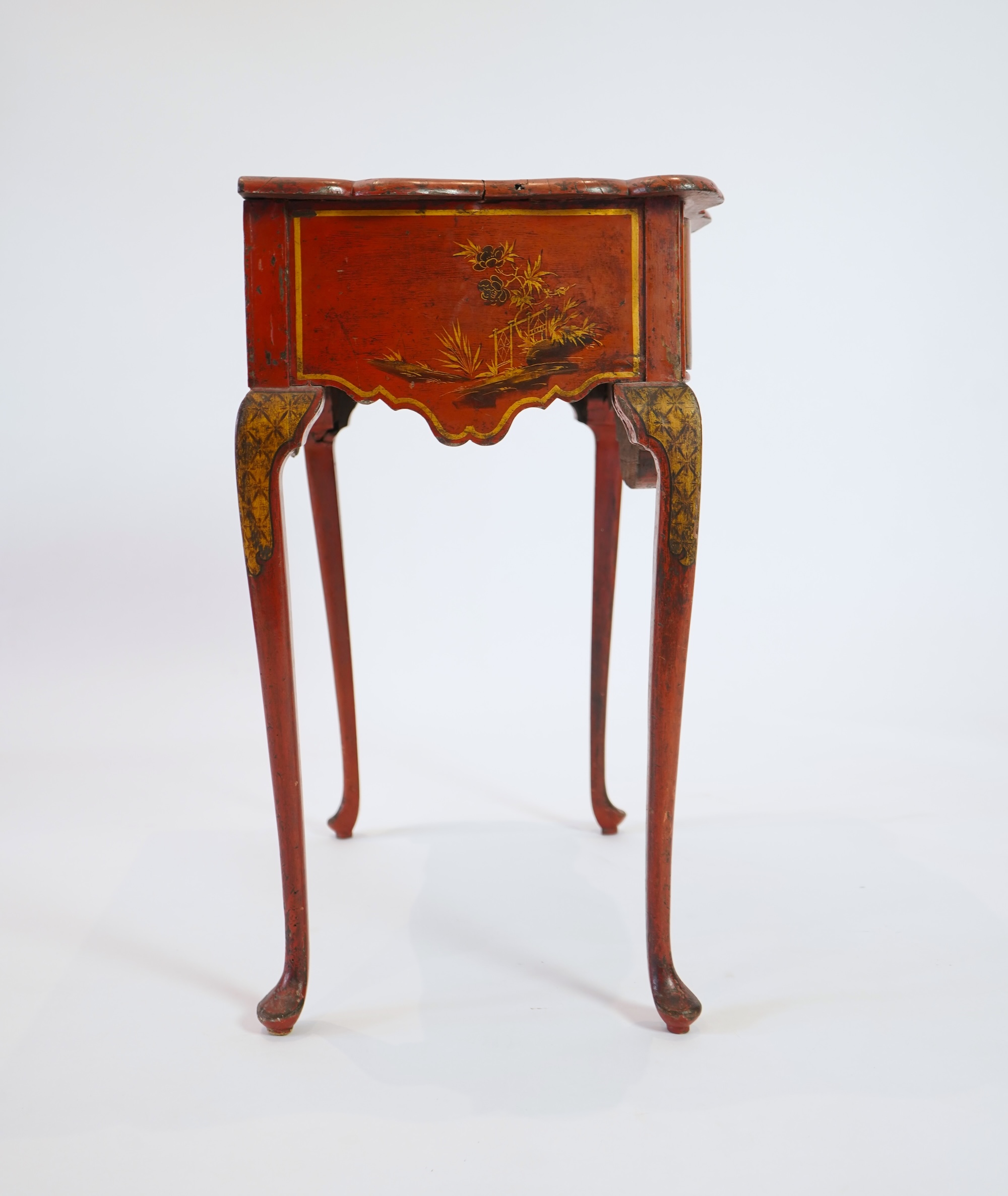 An early 18th century scarlet japanned lowboy